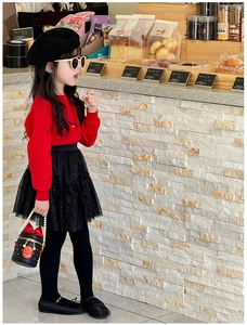 Detail of girls bucket bag with pearl handle and red silk ribbon on autumn outfit