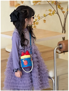 Detail of cute bow bucket bag with pearl chain and princess colors for girls