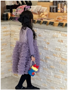Detail of girls' purple layered tulle dress and mini blue bag with pearl handle