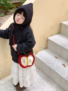 Handcrafted crochet apple-shaped crossbody bag for children featuring red and white knit textures