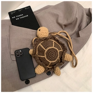 Detail of crochet turtle crossbody bag showing shell texture and knitting craftsmanship