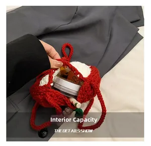 Detail shot showing the interior capacity of a handmade crochet apple-shaped crossbody bag