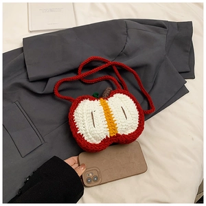 Close-up of handmade crochet apple-shaped shoulder bag with intricate knit texture