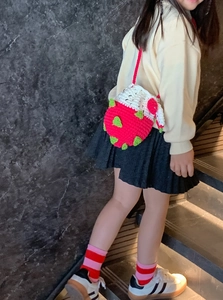 Sac bandoulière fraise tricoté à la main pour enfants porté par un enfant mannequin