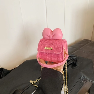 Detailed macro view of pink tweed mini bag with leather bow and golden Love logo
