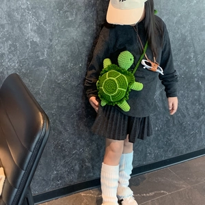 Cute crochet turtle crossbody bag for children with green knit shell and strap