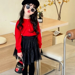 Red knit cardigan and black sequin tulle skirt set with pearl chain bucket bag