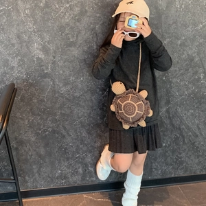Handmade crochet turtle bag for kids featuring brown and beige knitted patterns