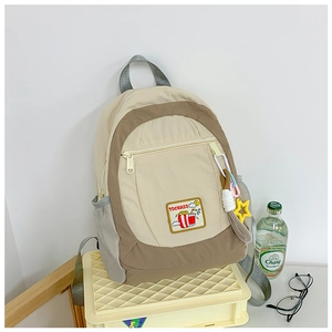 Detail view of multi-color kids backpack with star charm and popcorn patch detail