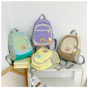 Detailed display of assorted Japanese style nylon school backpacks with cute star pendants