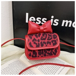 Close-up of red leopard print mini shoulder bag with a large leather bow decoration