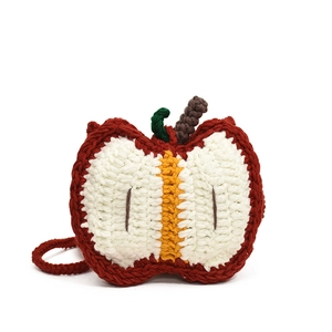 Handmade crochet apple crossbody bag for kids with red and white knit textures