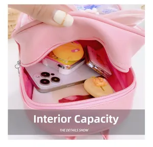 Internal capacity of pink girls' backpack showing phone, mirror and accessory storage