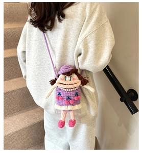 Détail d'un sac bandoulière en crochet fait main violet avec des motifs de cerises