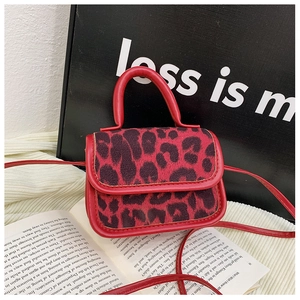 Close-up of red leopard print mini handbag with fine texture and leather strap