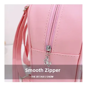 Detail of pink leather backpack featuring a smooth zipper with silver flower puller