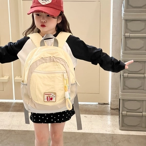 Light yellow lightweight kids backpack with cartoon patch and gray mesh side pockets