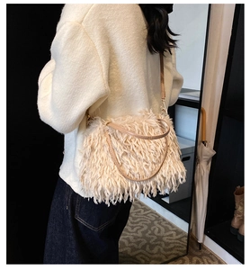Model view of cream faux fur crossbody bag with chain strap and plush fluffy texture