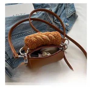 Detailed view of brown cylinder bag with plush bread charm and lipstick storage capacity