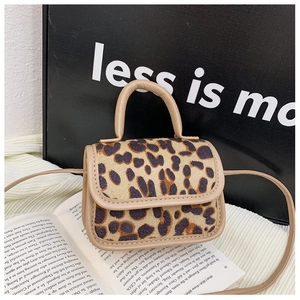 Close-up of leopard print mini bag with khaki leather trim and textured animal pattern