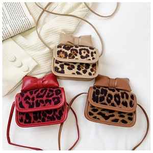 Detailed overhead view of mini leopard print girl handbags in red, beige and brown