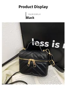 Detail of black quilted leather mini bag with gold zipper and stylish chain strap