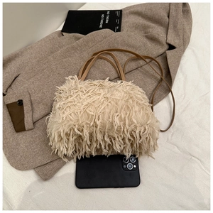 Macro detail of plush faux fur shoulder bag with leather strap and sizing reference