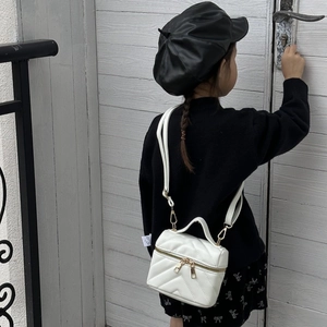 Chic white quilted mini crossbody bag for girls featuring gold hardware and a top handle