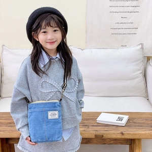 Denim blue crossbody bag for kids with fashion label and adjustable black strap