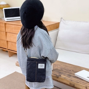 Kids black denim crossbody bag with yellow contrast stitching and white fashion label