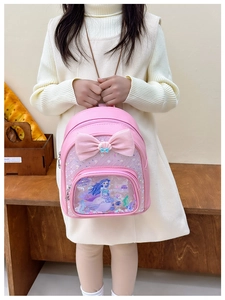 Detailed close-up of pink toddler backpack with a large bow and cartoon mermaid illustration