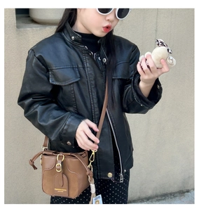 Girl's brown mini bucket bag styled with a black leather jacket in a trendy street look