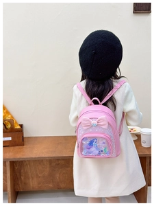 Detailed view of pink toddler backpack featuring a sequin bow and Little Mermaid design
