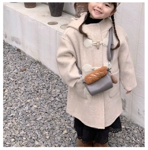 Close-up of beige faux fur coat for girls featuring classic wooden toggle buttons