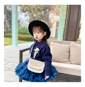 Fashionable navy blue girls tutu set with a beige plush-trim crossbody bag detail