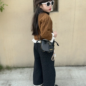 Girl's black leather mini bucket bag with gold buckle and stylish drawstring design