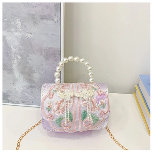Detail of purple satin handbag with flower embroidery and pearl handle