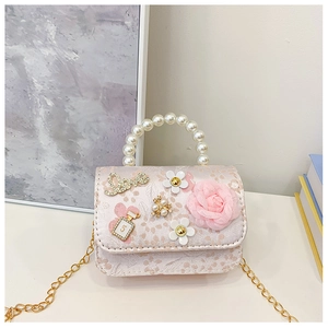 Detail of pink lace monkey bag with pearl handle and Love lettering with gold chain
