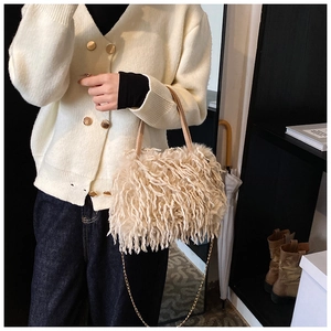 Chic cream faux fur handbag with elegant gold chain strap and soft plush tassels detail