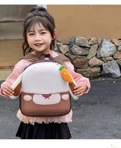 Détail d'un sac à dos chiot mignon avec oreilles 3D et charm carotte en peluche