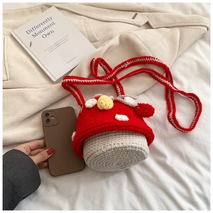 Close-up of handmade crochet mushroom crossbody bag with vibrant red and white knit textures