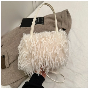 Detail of white faux fur handbag with leather handles and long fuzzy feather texture