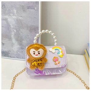 Detail showing purple monkey girl purse with white pearl handle and golden chain strap