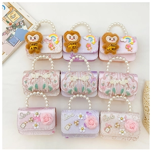 Detail of nine cute mini bags featuring pearl handles and 3D floral monkey decor