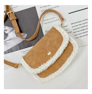 Close-up of brown faux leather mini bag with white faux shearling trim and gold clasp