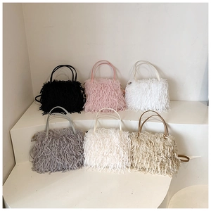 Variety of plush faux fur handbags in six colors displayed on white geometric steps