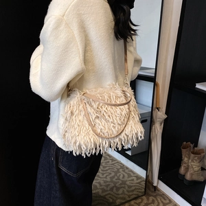 Beige faux fur crossbody bag with fringe texture and leather strap for autumn style