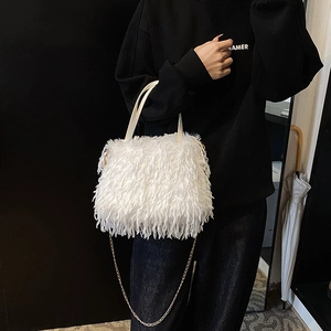 Chic white faux fur crossbody bag with golden chain strap and soft fringe texture