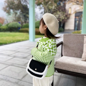 Fashionable kids crossbody bag with black matte texture and white faux fur trim details