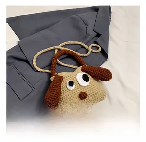 Detail of handmade crochet puppy shoulder bag with soft beige knit and brown floppy ears